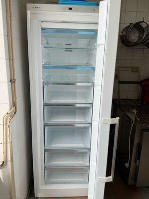 a white refrigerator with its door open in a kitchen