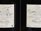 two bottles of wine sitting next to each other on a table