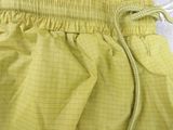 a close up of a pair of yellow pants with a tie