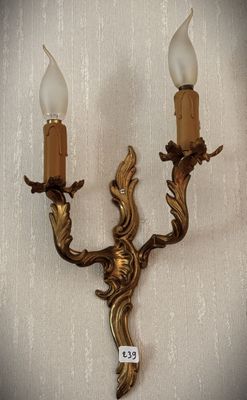 two candles that are on the wall next to each other