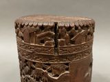 an old wooden box with carvings on it on a white surface