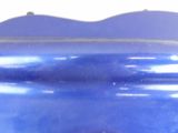 a close up of a blue vase on a table