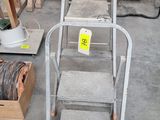a ladder that is sitting on the floor next to other items
