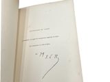 an open book with a handwritten signature on the front of it