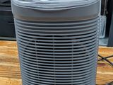 a small air purifier sitting on a wooden table