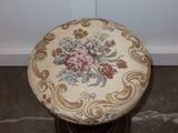 a small stool with a floral design on it