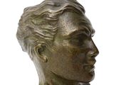 bronze statue of a woman ' s head on a white background