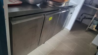 a stainless steel counter with a bowl on top of it