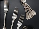 a lot of forks and spoons on the table