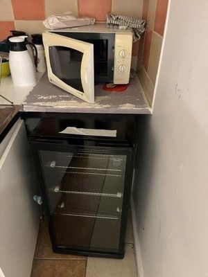 a microwave oven sitting on top of a counter in a small kitchen