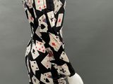 a mannequin wearing a black and white dress with playing cards on it