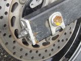 a close up of a motorcycle wheel with a bolt