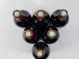 six bottles of wine are arranged in a circle on a white surface