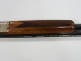 a shotgun with a wooden handle on a white surface
