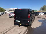 the van is parked in the parking lot near many other cars