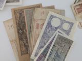 many different types of foreign currency on the table