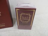 an image of a bottle of perfume next to a box of perfume