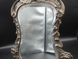a mirror that is sitting on a black surface