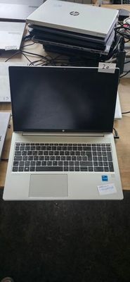 two laptops sitting on a table next to each other