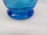 a blue glass bowl sitting on top of a white table