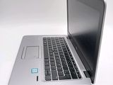 a silver laptop with a blue sticker on the screen