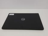 the dell laptop is sitting on a table with a white background