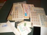 une pile de timbres posée sur une table, à côté d'une feuille de papier