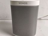 a white and black sonos speaker sitting on top of a table