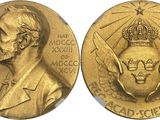 a close up of a gold medal with a crown on it