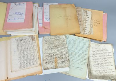 several old papers are stacked on top of each other on a table