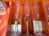 four empty wine glasses in a box on a table