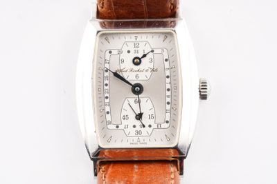 a close up of a watch on a white surface
