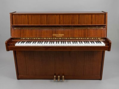 a piano with a wooden case sitting on top of it