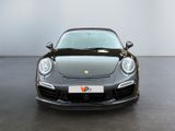 the front of a black porsche sports car parked in a garage