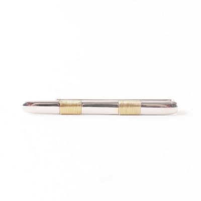 a close up of a pen on a white surface with a white background