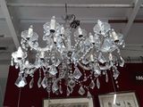 a crystal chandelier hanging from the ceiling in a room