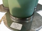 two green vases sitting on top of each other