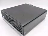 the back of a small black computer on a white surface