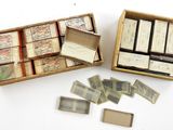 two boxes of stamps and a box of stamps on a white surface