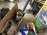 a pile of junk on the ground next to a trash can