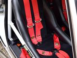 two seats in the back of a car that are red and black