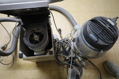 a blow dryer sitting on the floor next to a laptop computer