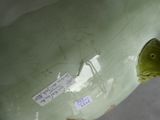 a green vase with a fish on it and a sticker on it
