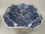 two blue and white bowls sitting next to each other