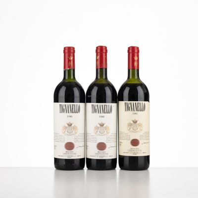 three bottles of wine sitting on top of a white table