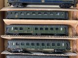 four train cars that are sitting in a cardboard box