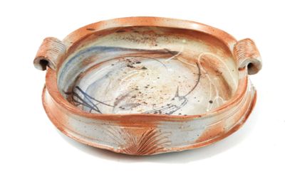 a brown and white bowl on a white surface
