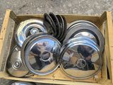 a box with a bunch of silver pots and pans in it