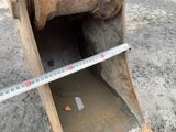 a close up of a metal bucket with a measuring tape on it