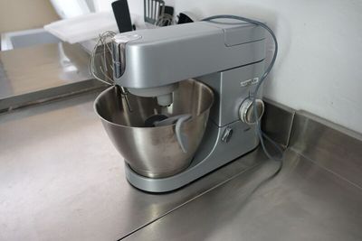 a silver mixer with a metal bowl on the counter